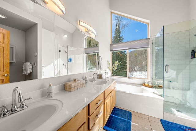 full bathroom featuring tile patterned flooring, a shower stall, double vanity, and a sink