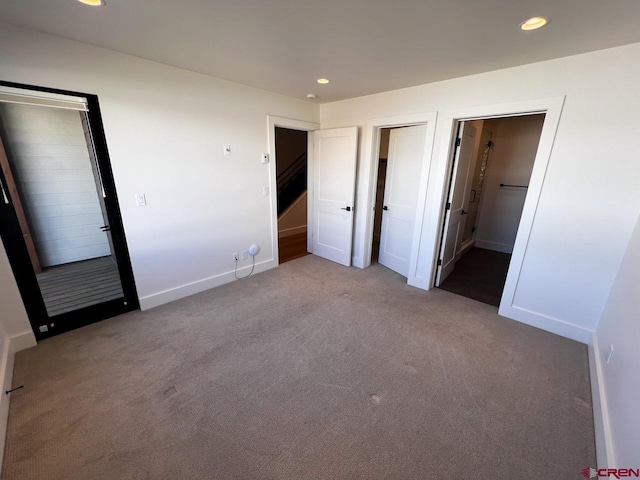 unfurnished bedroom with recessed lighting, baseboards, and carpet