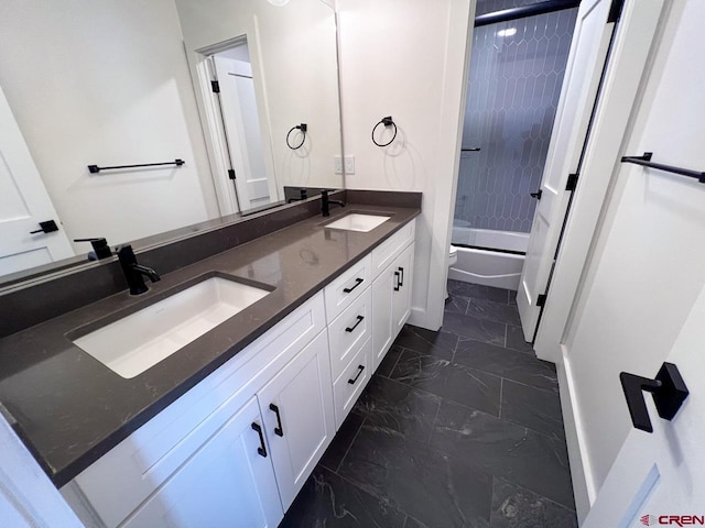 bathroom featuring a sink, tub / shower combination, marble finish floor, and double vanity