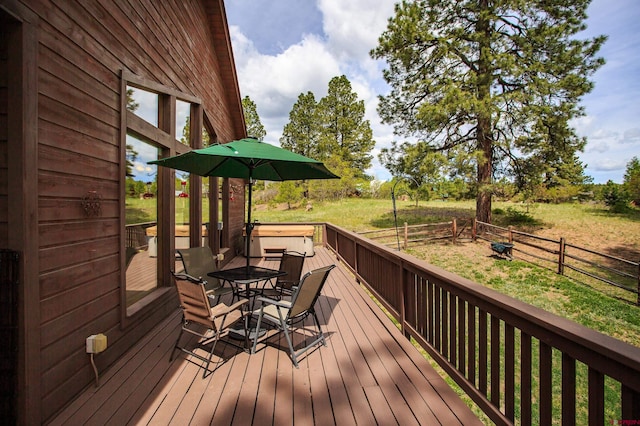 wooden deck featuring outdoor dining space and fence