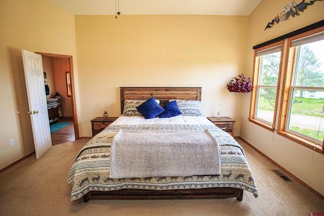 carpeted bedroom featuring visible vents and baseboards