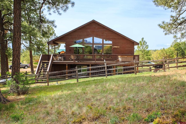 back of house featuring a deck and fence