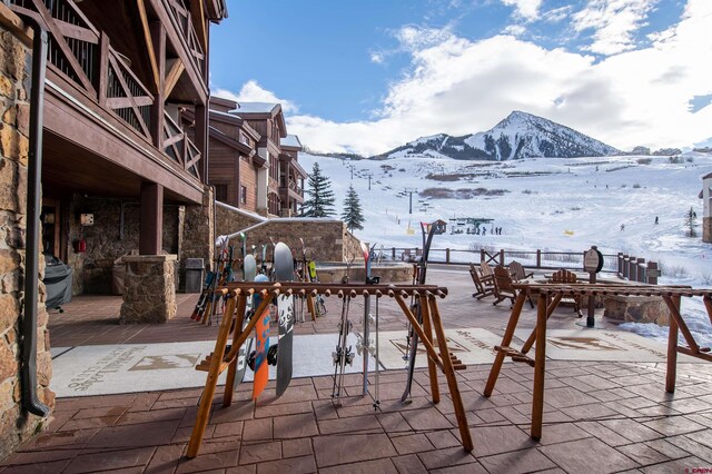 14 Hunter Hill Rd Unit C302, Mount Crested Butte, CO 81225 - snow covered patio with a mountain view and outdoor dining area