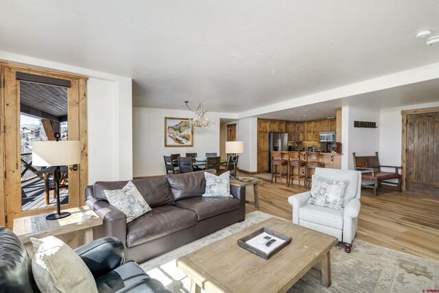 14 Hunter Hill Rd Unit C302, Mount Crested Butte, CO 81225 - living room featuring light wood-style floors and a chandelier