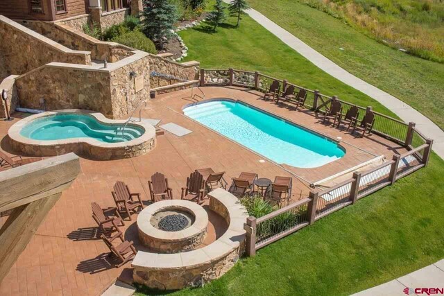 14 Hunter Hill Rd Unit C302, Mount Crested Butte, CO 81225 - pool featuring a patio, fence, a lawn, and a fire pit