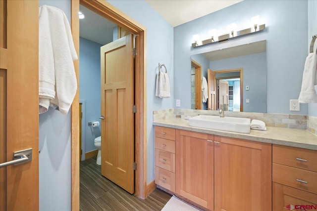 bathroom with toilet and vanity