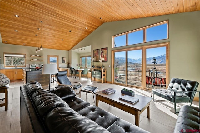 living area with recessed lighting, a mountain view, high vaulted ceiling, and wooden ceiling