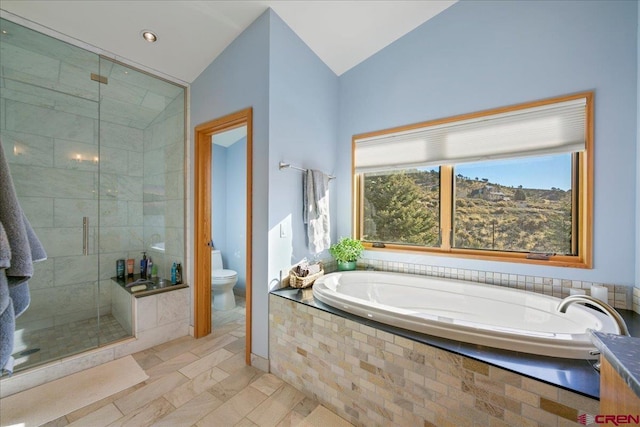 full bathroom featuring toilet, lofted ceiling, a bath, and a stall shower
