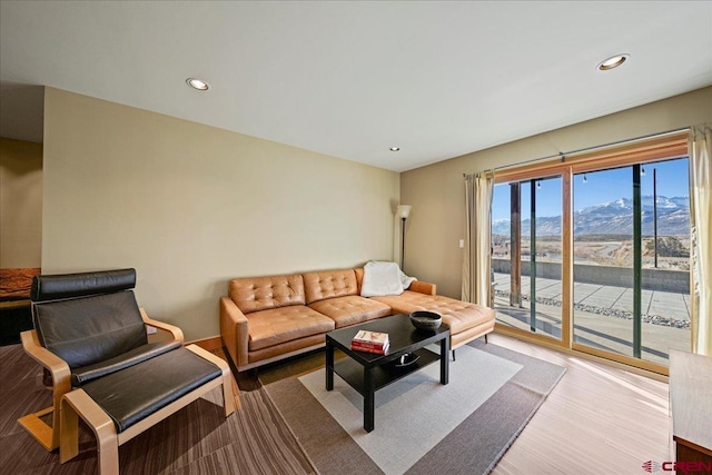 living room featuring recessed lighting, a mountain view, and wood finished floors