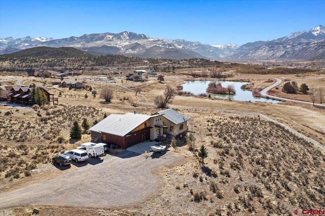 birds eye view of property featuring a water and mountain view