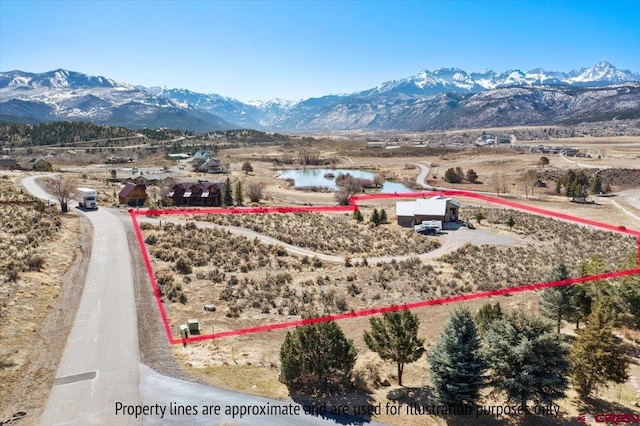birds eye view of property with a mountain view