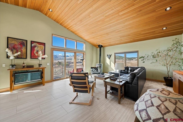 living area with baseboards, high vaulted ceiling, a wood stove, a fireplace, and wood ceiling