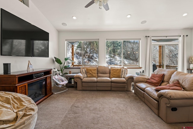 carpeted living room featuring a glass covered fireplace, recessed lighting, and a ceiling fan