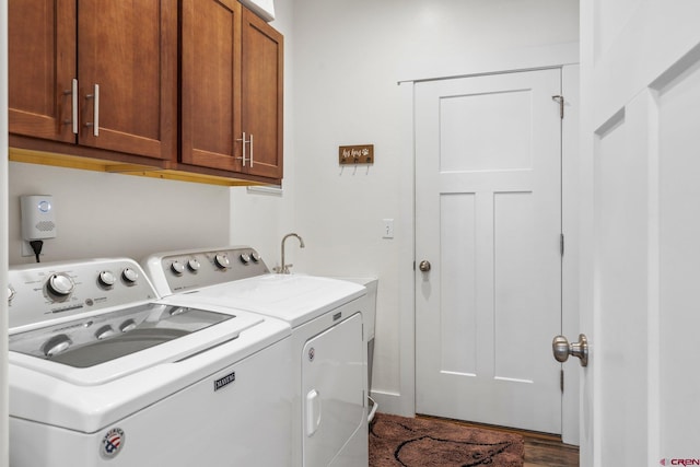 washroom featuring washer and dryer and cabinet space