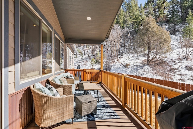 snow covered deck with an outdoor hangout area