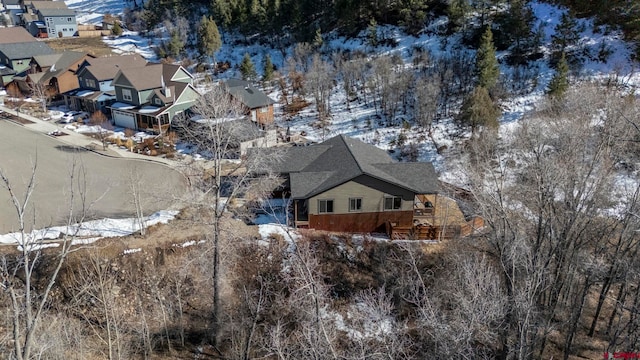 snowy aerial view with a residential view