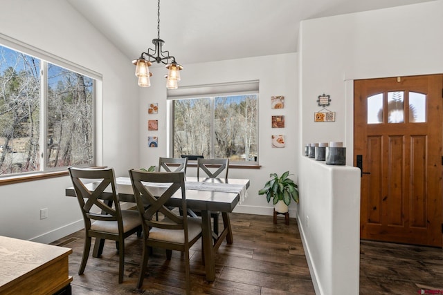 dining space featuring a wealth of natural light, baseboards, lofted ceiling, and dark wood-style flooring