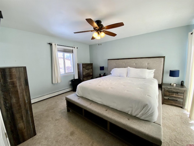 carpeted bedroom with a baseboard heating unit and a ceiling fan