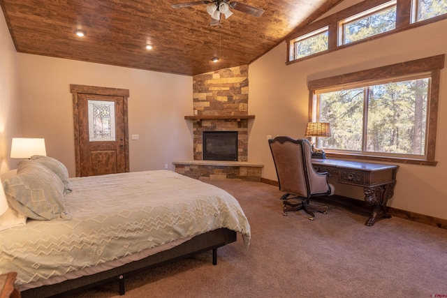 carpeted bedroom featuring baseboards, high vaulted ceiling, recessed lighting, a stone fireplace, and wooden ceiling