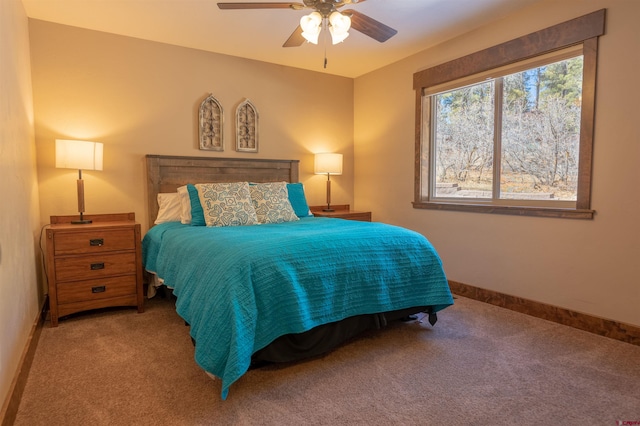 carpeted bedroom with a ceiling fan and baseboards