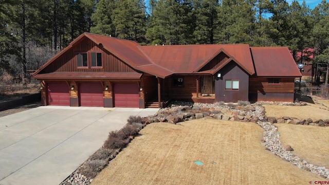 view of front of property with covered porch, concrete driveway, and a garage