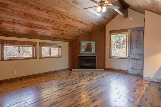 unfurnished living room featuring a healthy amount of sunlight, lofted ceiling, and wood-type flooring