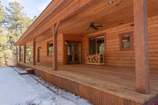 wooden terrace with a porch and a ceiling fan