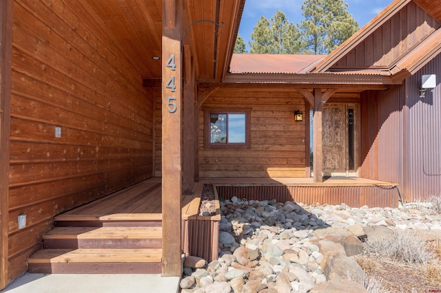 entrance to property with metal roof, board and batten siding, and a porch