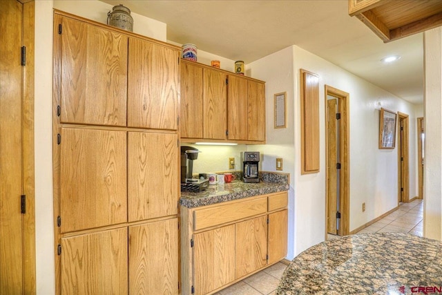 kitchen featuring dark countertops and light tile patterned floors