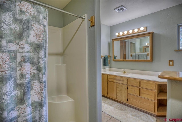 bathroom with vanity and a shower with curtain