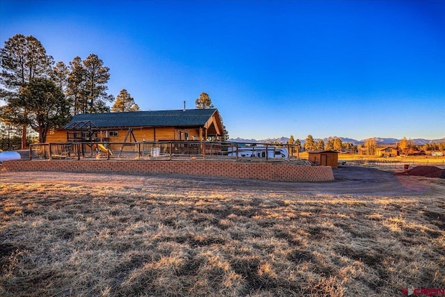 exterior space with a mountain view, an outdoor structure, and a shed