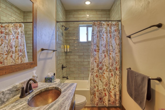 bathroom with wood finished floors, toilet, shower / bath combo, and vanity