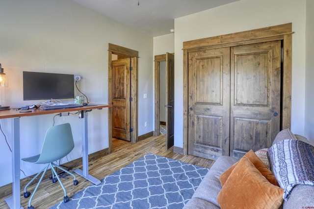 office area featuring baseboards and wood finished floors