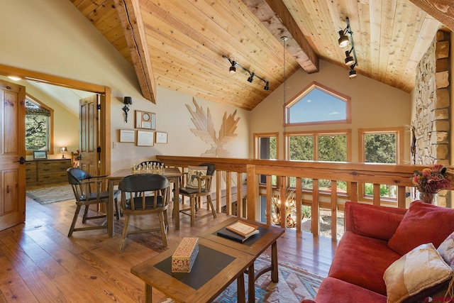 living room featuring beam ceiling, high vaulted ceiling, hardwood / wood-style floors, wooden ceiling, and rail lighting