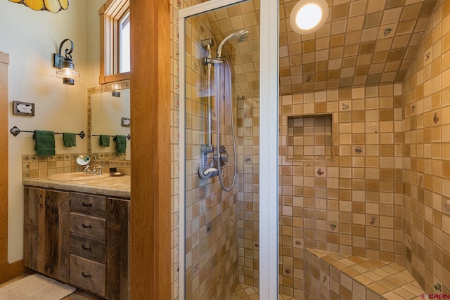 full bath with vanity and a shower stall