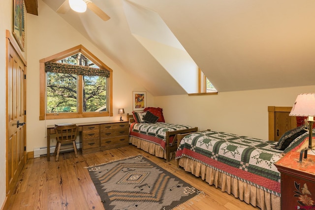 bedroom featuring a baseboard heating unit, hardwood / wood-style flooring, a ceiling fan, and vaulted ceiling