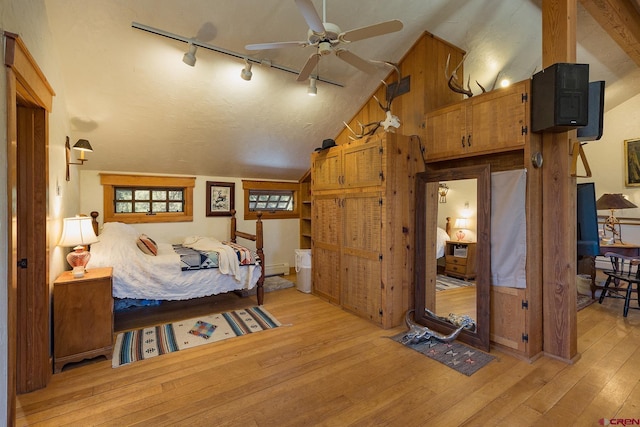 bedroom with light wood-type flooring and lofted ceiling