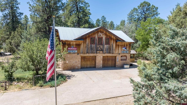 view of front of property with concrete driveway and a garage