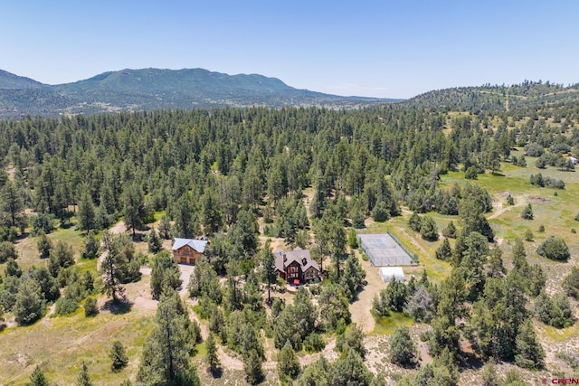 aerial view featuring a mountain view and a forest view