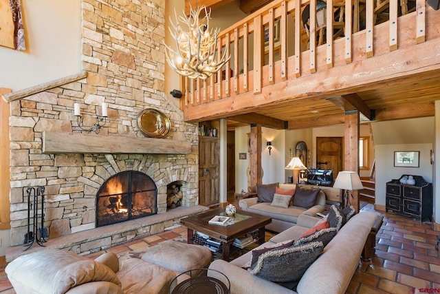 living area with a chandelier, beam ceiling, a fireplace, a high ceiling, and brick floor