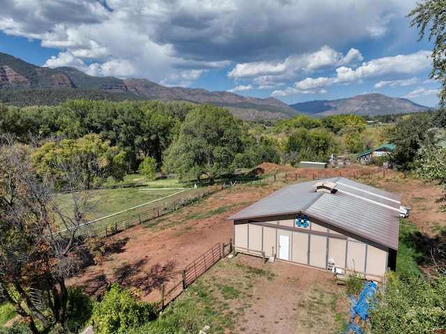 aerial view with a forest view, a mountain view, and a rural view