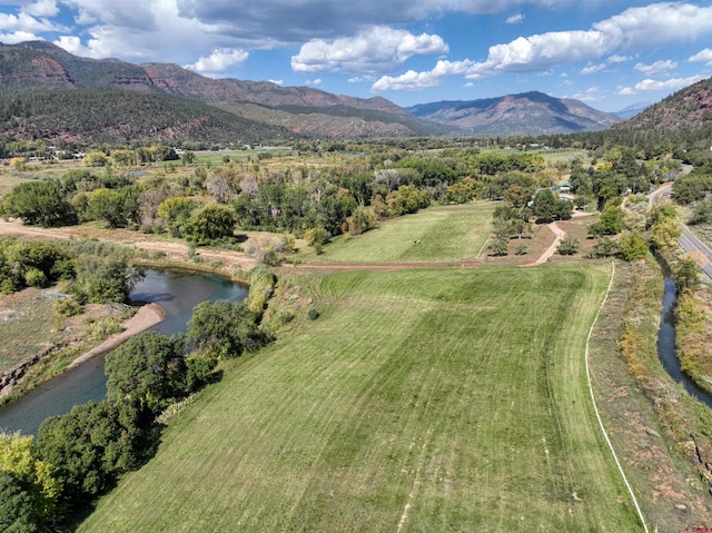 bird's eye view with a water and mountain view