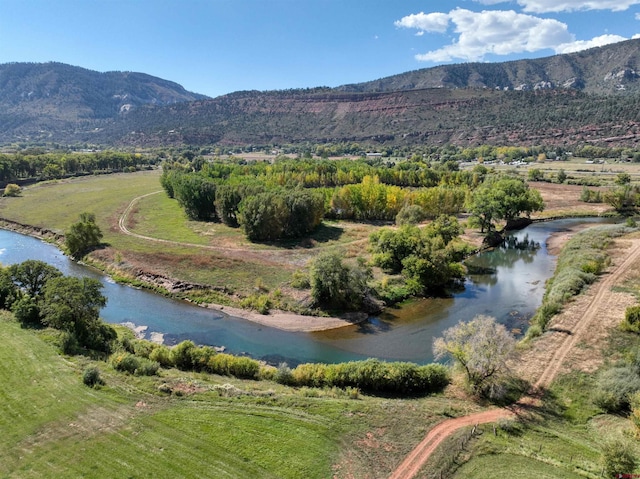 aerial view featuring a water and mountain view