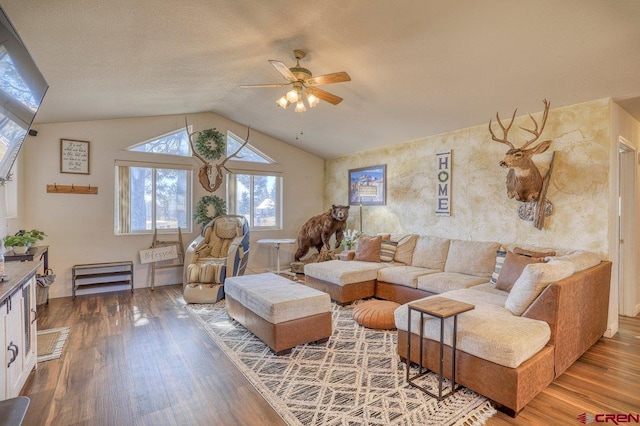 living area with vaulted ceiling, baseboards, a ceiling fan, and wood finished floors