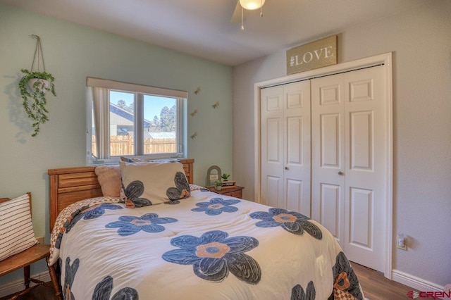 bedroom featuring a closet, baseboards, a ceiling fan, and wood finished floors