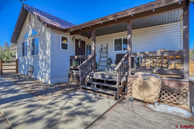 view of front of home featuring a porch and metal roof