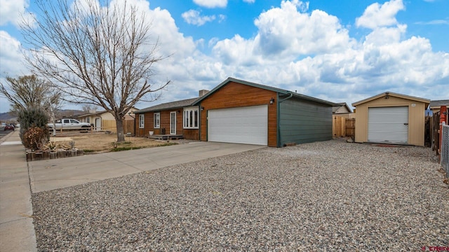 ranch-style home featuring driveway, a garage, and fence