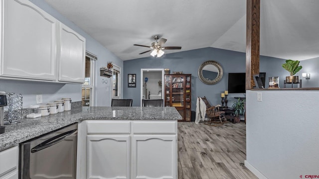 kitchen featuring light stone counters, a peninsula, lofted ceiling, white cabinetry, and light wood-type flooring