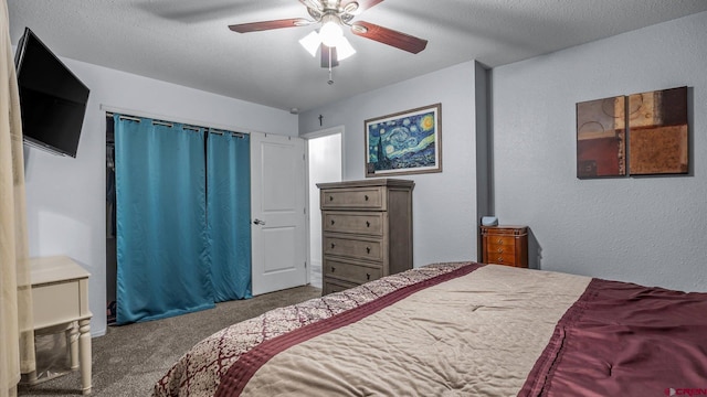 carpeted bedroom featuring a textured ceiling, a ceiling fan, and a textured wall