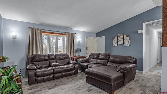 living room featuring baseboards, lofted ceiling, and light wood-style flooring